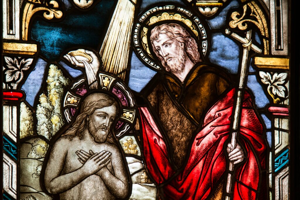 Depicts a detailed stained glass artwork featuring biblical scenes in vivid colors.